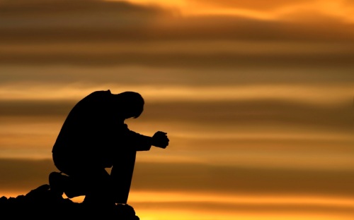 praying-and-kneeling-man